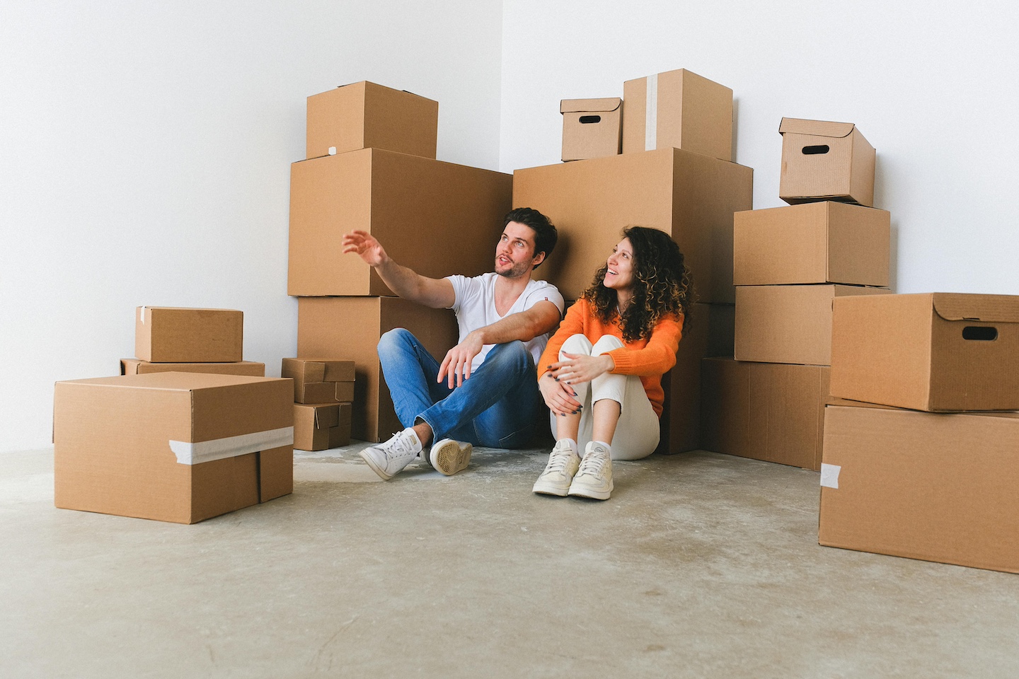 Couple sitting in lounge with moving boxes